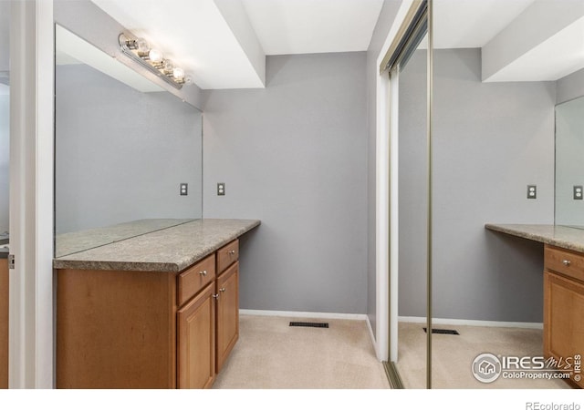 bathroom featuring visible vents, vanity, and baseboards