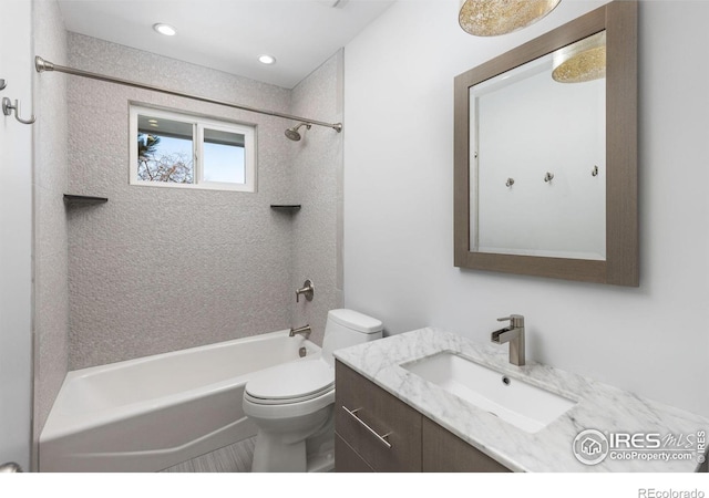 bathroom with toilet, tub / shower combination, and vanity