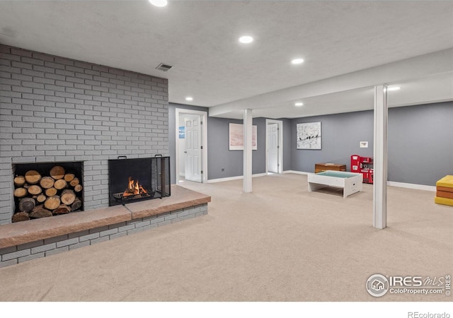 finished basement with recessed lighting, a fireplace, baseboards, and light colored carpet