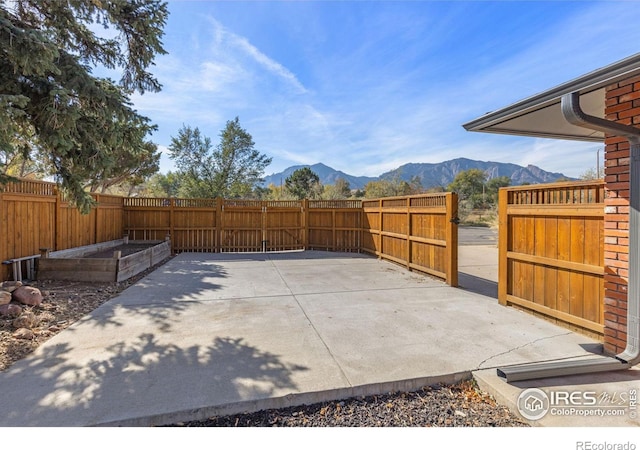 view of patio featuring a fenced backyard and a mountain view