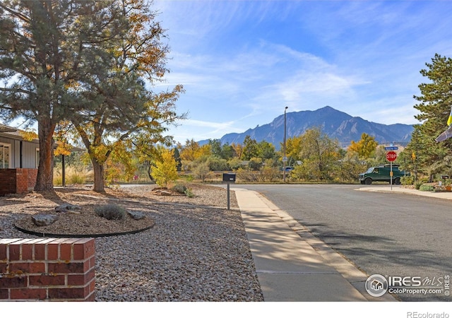 exterior space featuring street lighting, traffic signs, and a mountain view