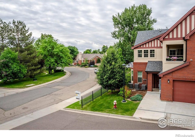 view of front of property featuring cooling unit and a garage