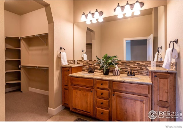 bathroom featuring vanity and decorative backsplash