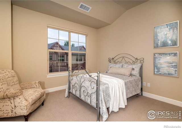 bedroom featuring vaulted ceiling and carpet