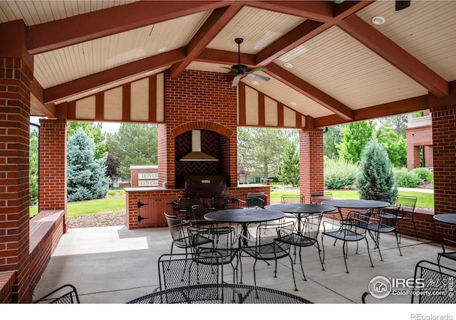 view of patio with a bar, area for grilling, ceiling fan, an outdoor brick fireplace, and a gazebo