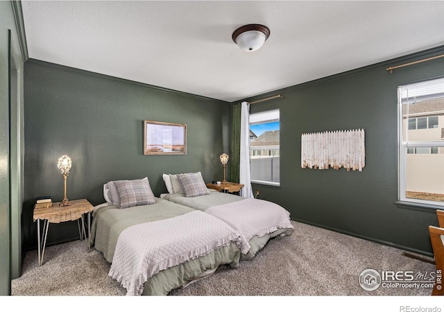 carpeted bedroom featuring crown molding and multiple windows