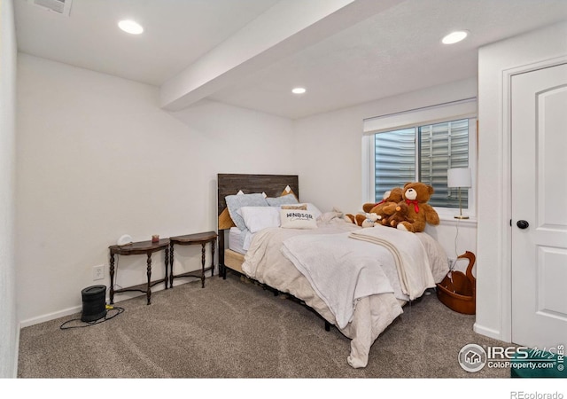 carpeted bedroom featuring beamed ceiling