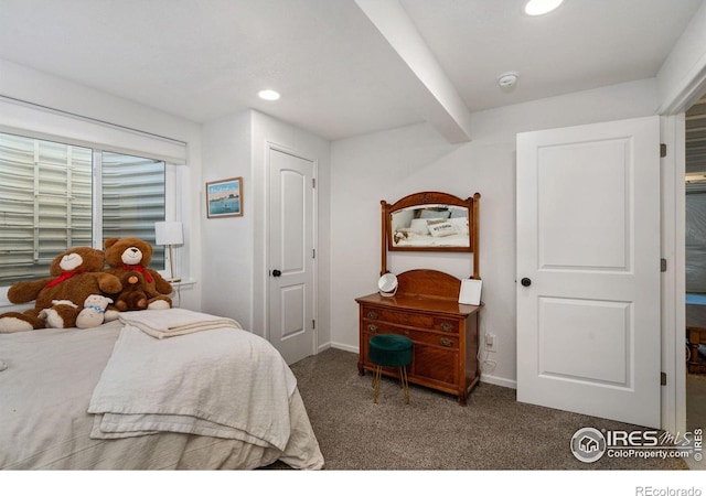 bedroom featuring dark carpet