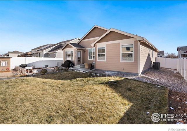 view of front of property with central AC and a front yard