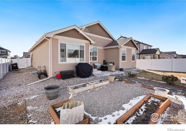 view of snow covered rear of property