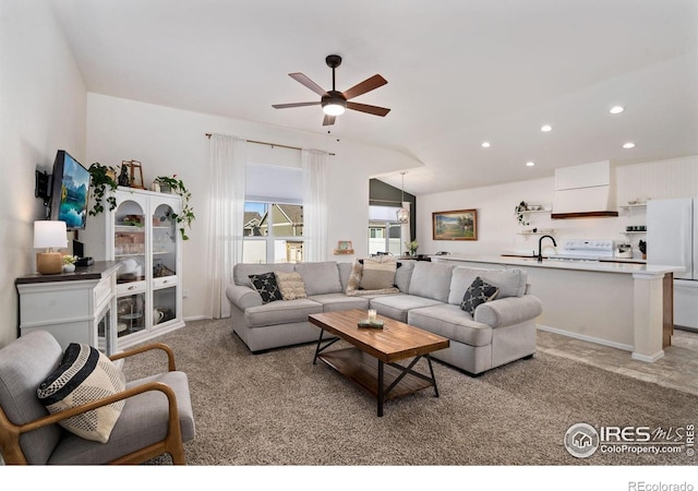 carpeted living room featuring lofted ceiling and ceiling fan