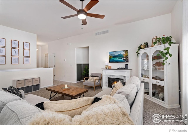 living room featuring carpet flooring and ceiling fan