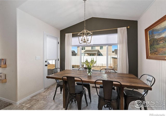 dining area with vaulted ceiling and a notable chandelier