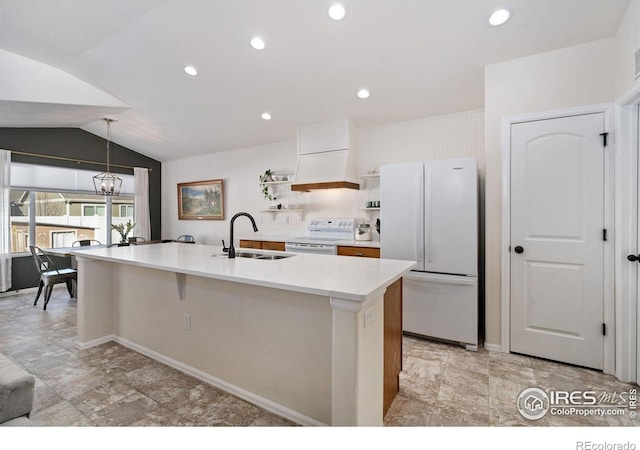 kitchen featuring sink, white cabinetry, decorative light fixtures, an island with sink, and white appliances