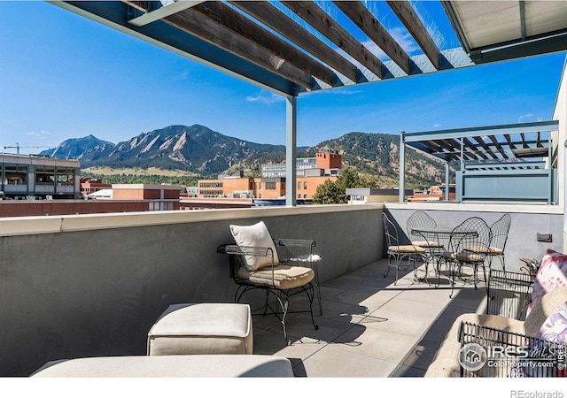 view of patio featuring a pergola and a mountain view