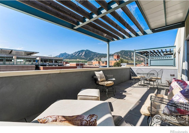 view of patio / terrace with a mountain view and a pergola