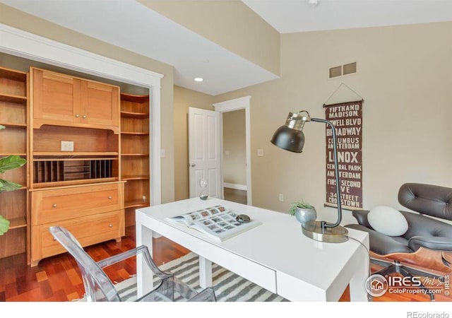 office area with dark hardwood / wood-style floors and vaulted ceiling