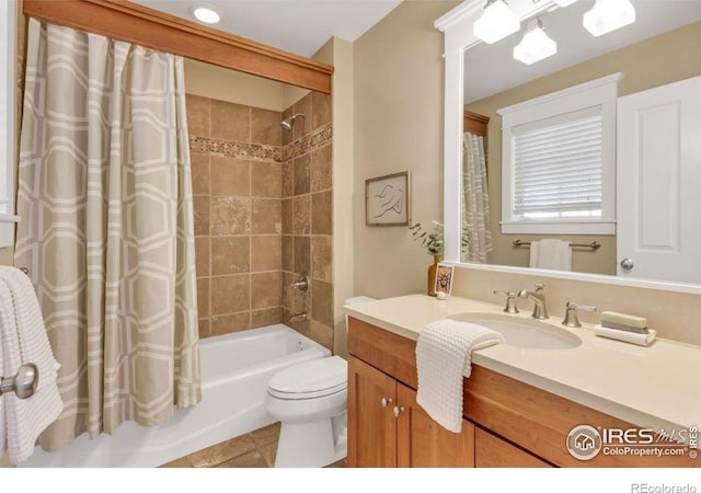 full bathroom featuring shower / bathtub combination with curtain, vanity, tile patterned floors, and toilet