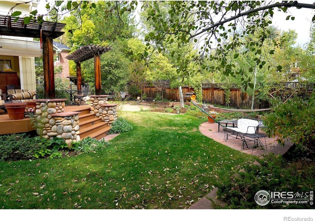 view of yard featuring a pergola and a patio area