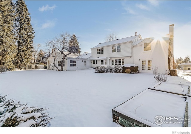 snow covered property with french doors