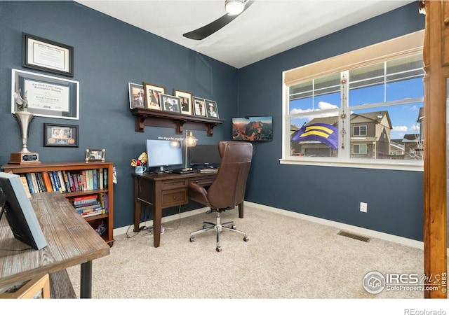 carpeted home office with ceiling fan