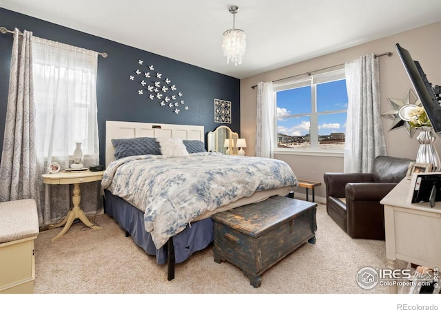 carpeted bedroom with a chandelier