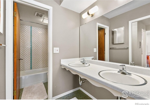 bathroom featuring dual sinks and  shower combination