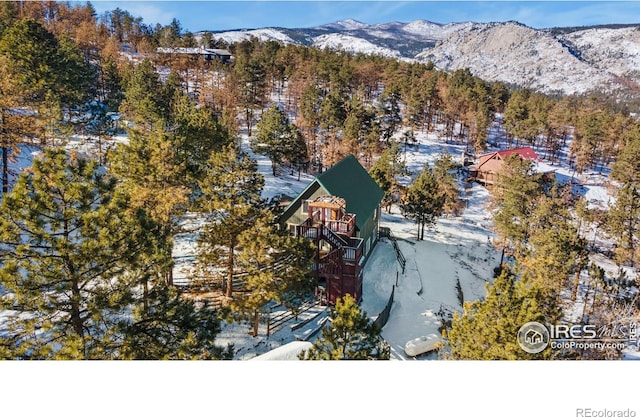 snowy aerial view featuring a mountain view