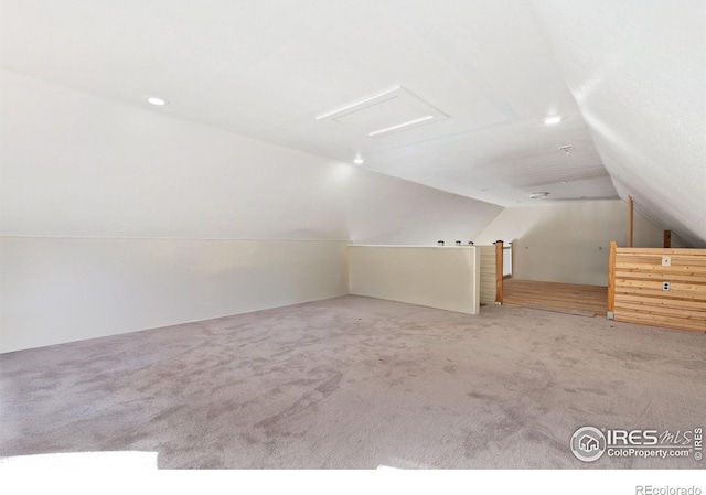 bonus room featuring carpet floors and vaulted ceiling