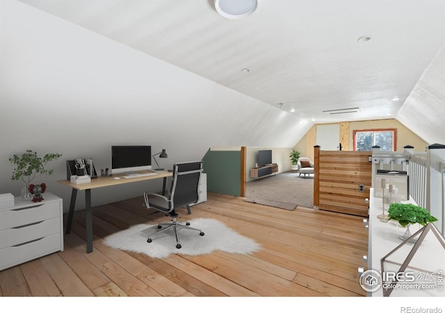 office space featuring wood-type flooring and vaulted ceiling