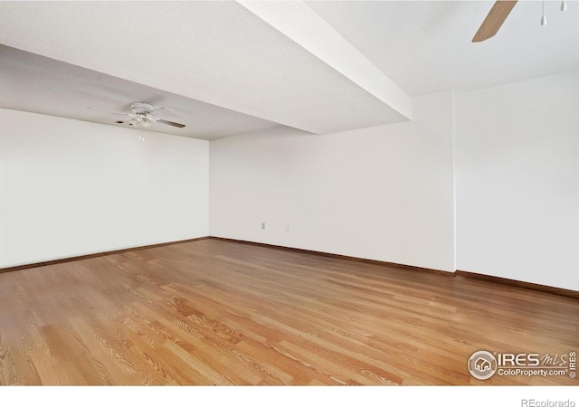 spare room featuring ceiling fan and light hardwood / wood-style floors