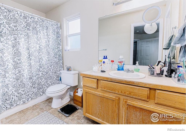 bathroom featuring vanity, toilet, and tile patterned flooring