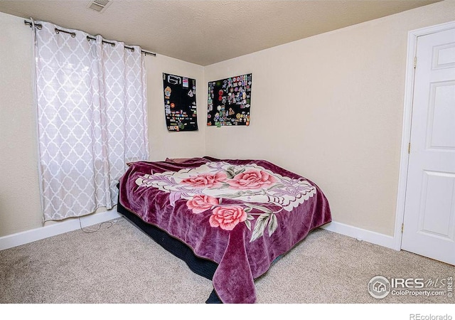 carpeted bedroom with a textured ceiling