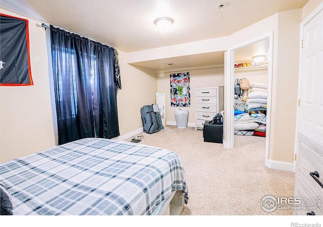 bedroom with a closet, a textured ceiling, and carpet flooring