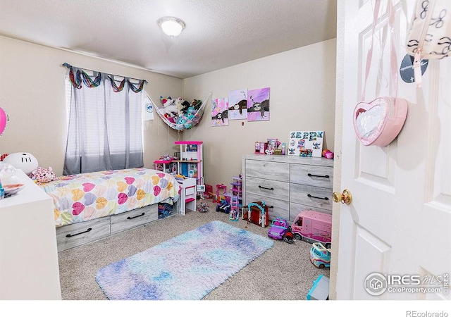 bedroom with carpet and a textured ceiling