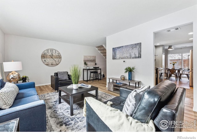 living room with hardwood / wood-style floors and ceiling fan