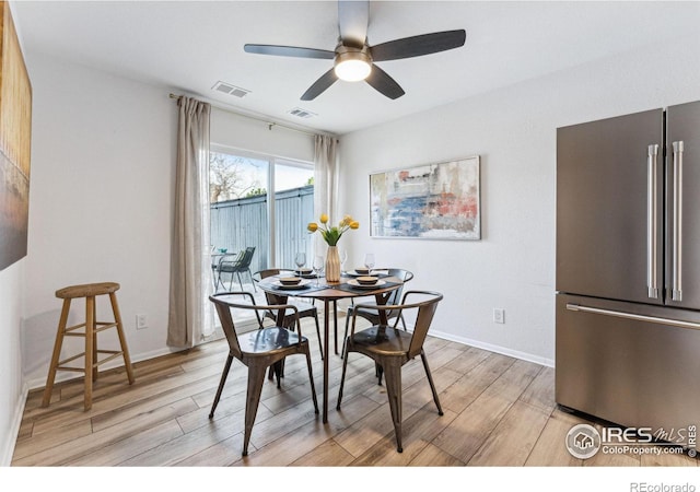 dining room with ceiling fan and light wood-type flooring