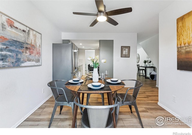 dining area with wood-type flooring and ceiling fan