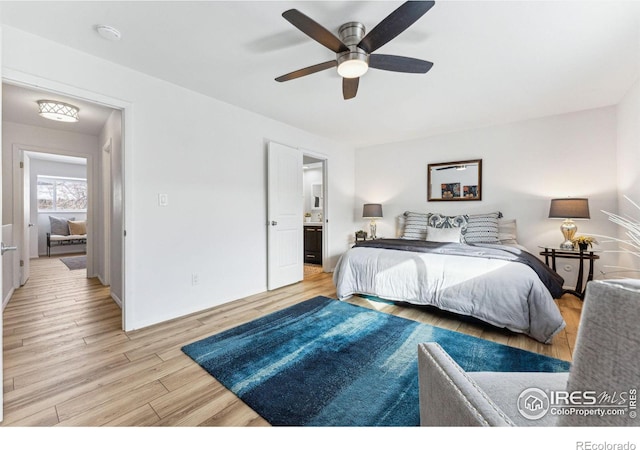 bedroom featuring ensuite bathroom, light wood-type flooring, and ceiling fan