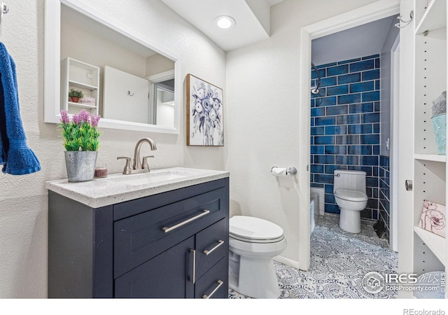 full bathroom with tile patterned floors, toilet, tiled shower / bath combo, and vanity