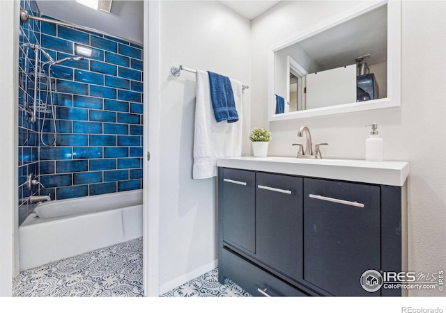 bathroom with tile patterned flooring, vanity, and tiled shower / bath combo