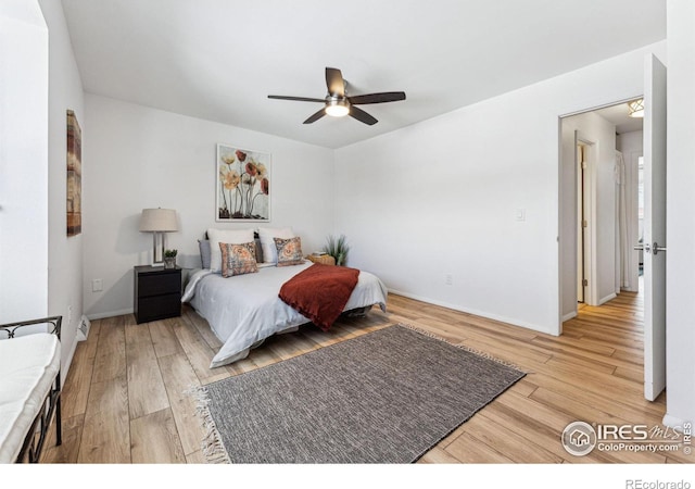 bedroom with light hardwood / wood-style flooring and ceiling fan