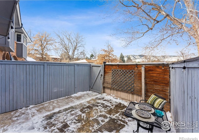 snow covered deck with a mountain view