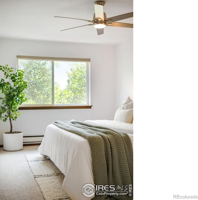 bedroom with light carpet, a baseboard radiator, and ceiling fan