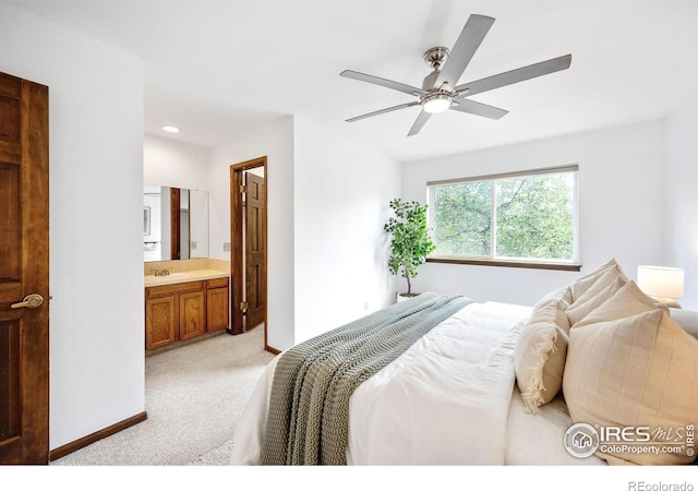 bedroom with light carpet, sink, connected bathroom, and ceiling fan