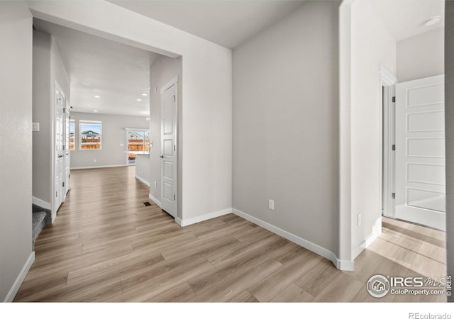 corridor featuring light hardwood / wood-style floors