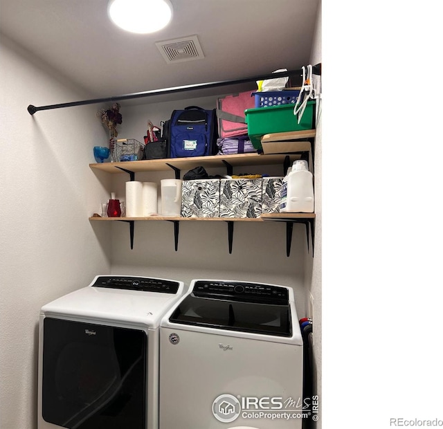 washroom featuring washer and clothes dryer