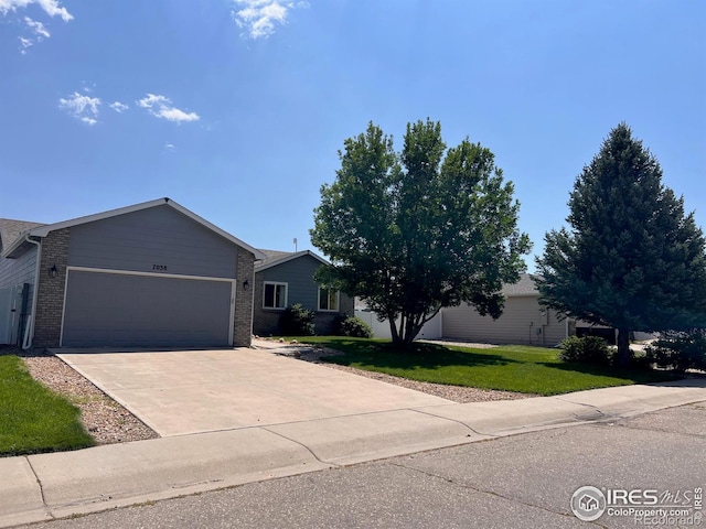 view of front of home featuring a garage and a front lawn