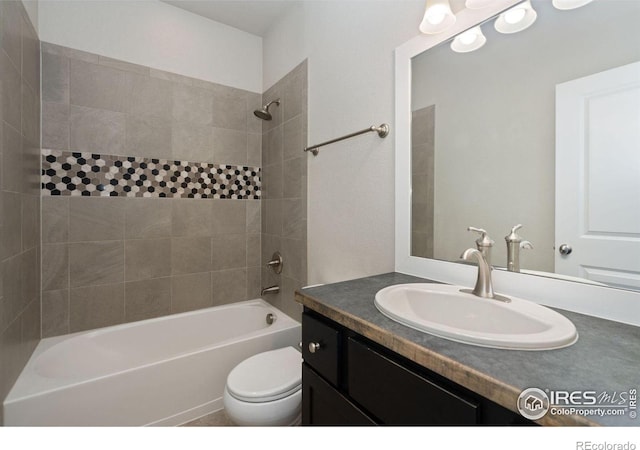 full bathroom with vanity, toilet, and tiled shower / bath