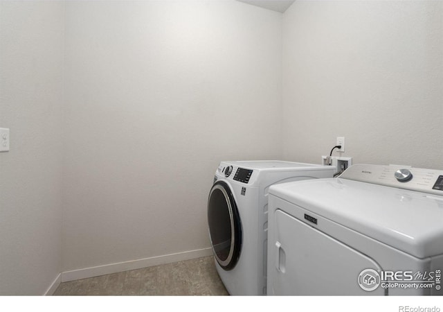 laundry area with washing machine and clothes dryer